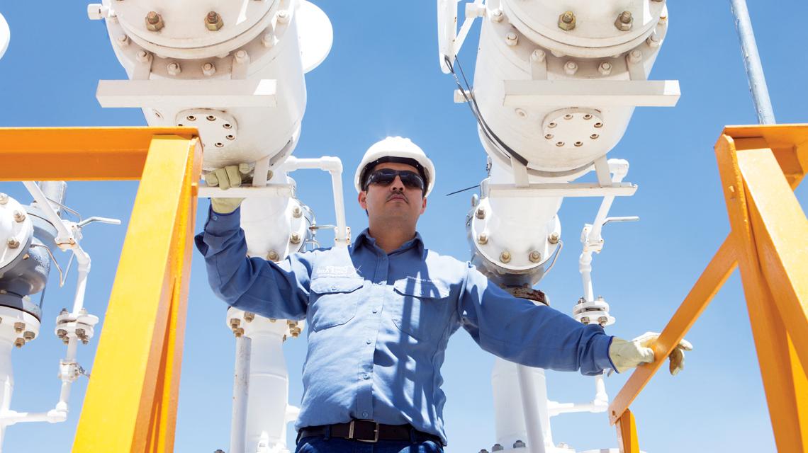 A Sempra Infrastructure team member stands in a project site